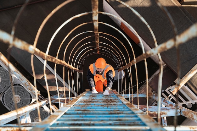 Full shot man climbing ladder