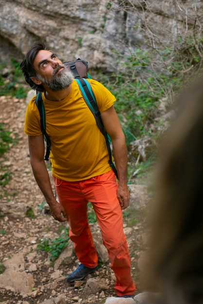 Free photo full shot man climbing in the mountains