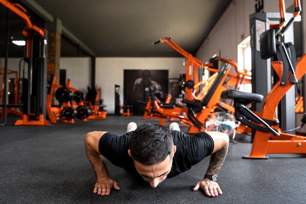 Full shot man doing burpees