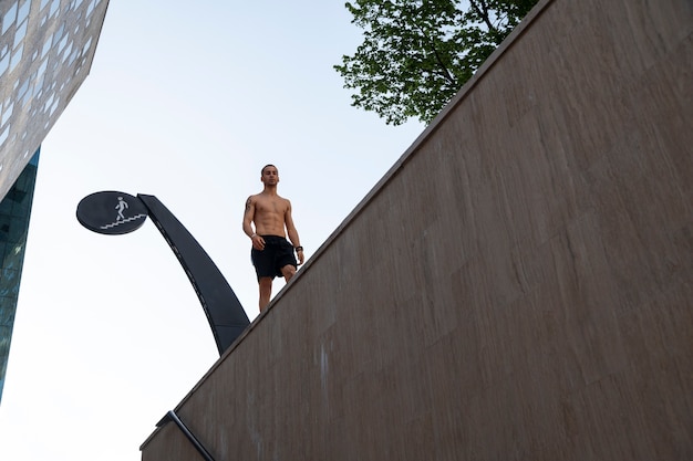 Free photo full shot man doing parkour training