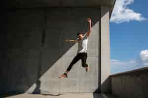 Free photo full shot man doing  parkour training