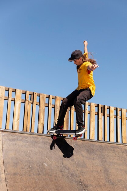 Full shot man doing tricks on ramp