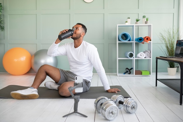 Full shot man drinking water