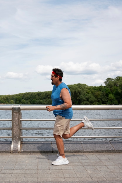 Free photo full shot man exercising outdoors