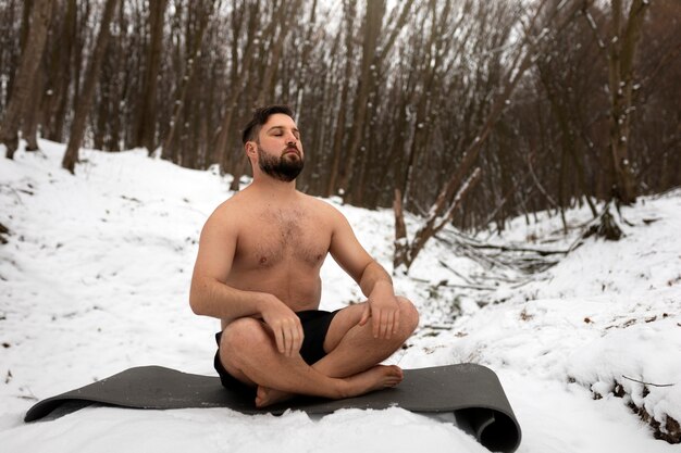 Full shot man experiencing cold exposure for wellness
