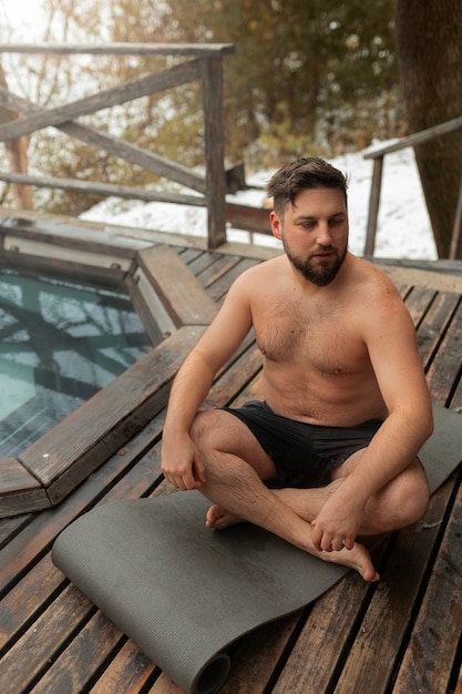 Full shot man experiencing cold exposure for wellness