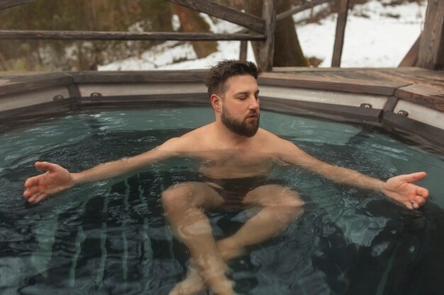 Full shot man experiencing cold exposure for wellness