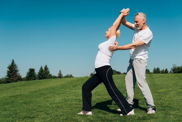 Full shot man helping woman straighten her back