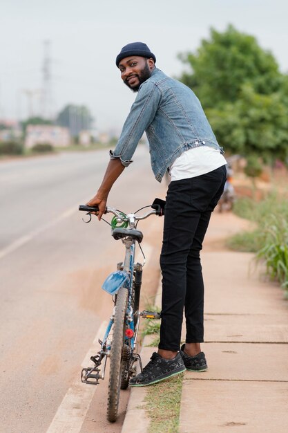 Full shot man holding bicycle