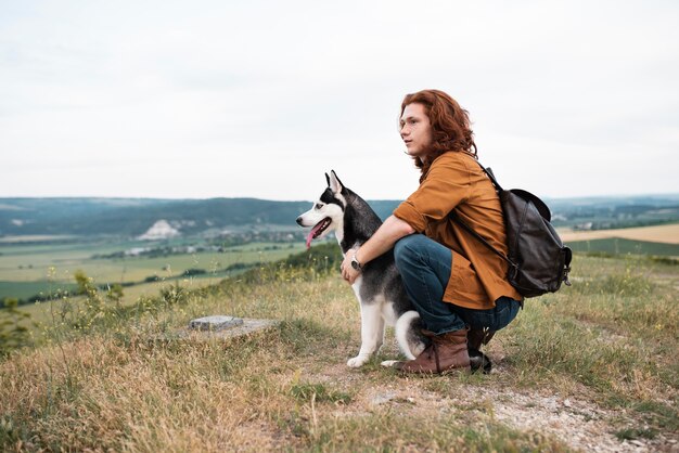 Full shot man holding dog outside