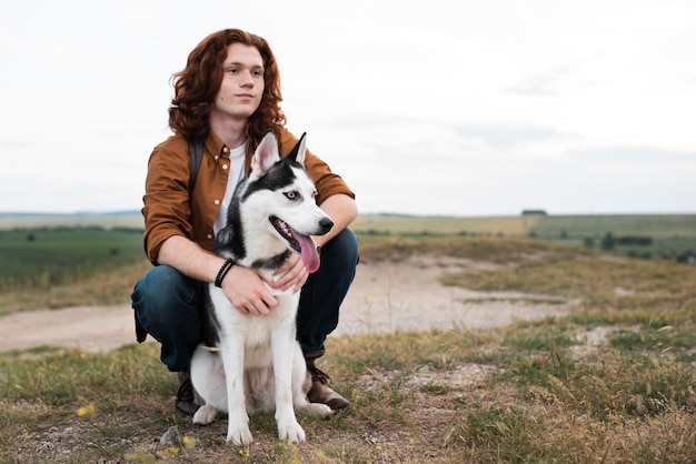 Full shot man holding dog