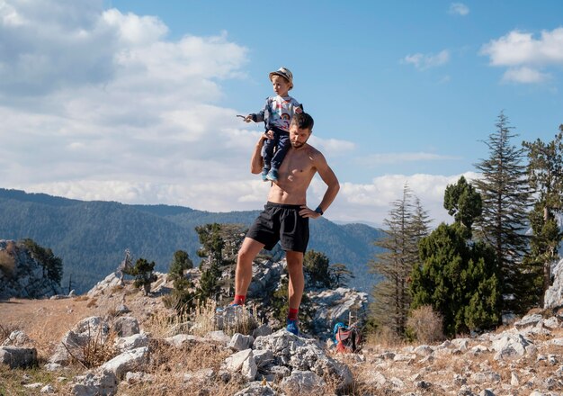 Full shot man holding kid