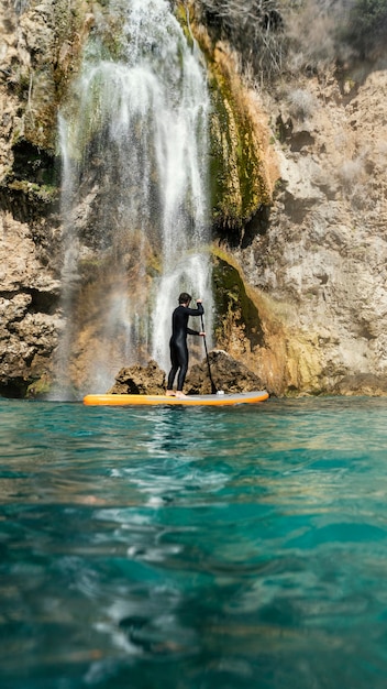 Full shot man holding paddle