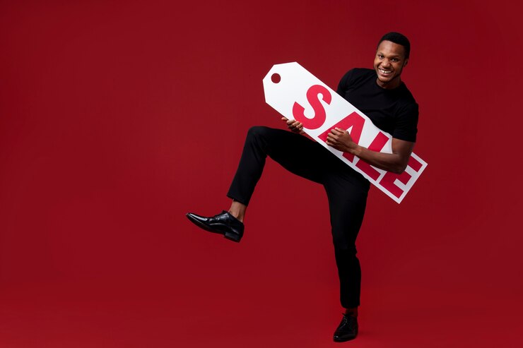 Free Photo full shot man holding sale tag