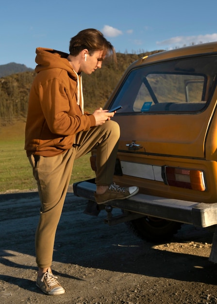 Full shot man holding smartphone