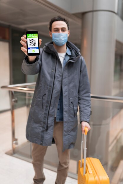 Full shot man holding smartphone