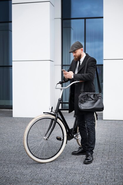 Full shot man holding smartphone