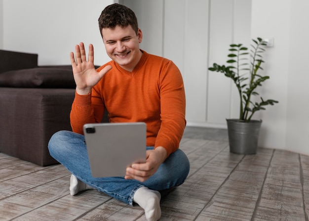 Full shot man holding tablet