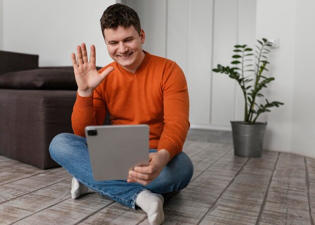 Full shot man holding tablet