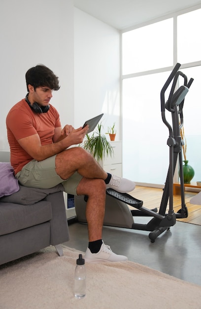 Full shot man holding tablet