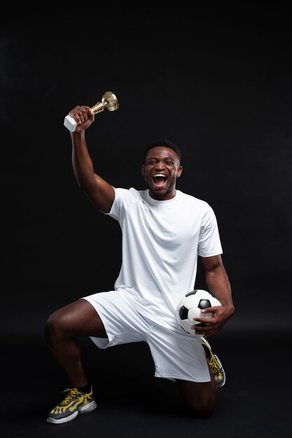 Full shot man holding trophy