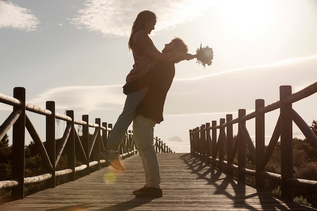 Full shot man holding woman