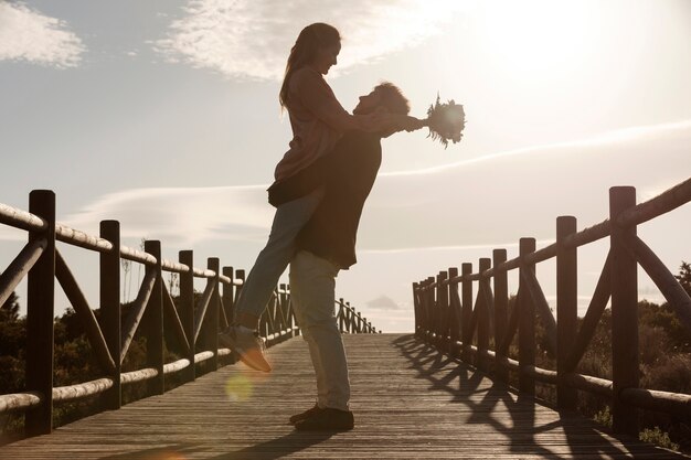 Full shot man holding woman