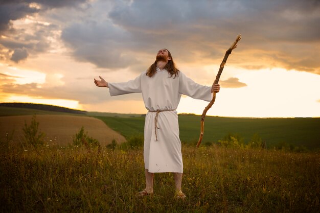 Full shot man holding wooden stick