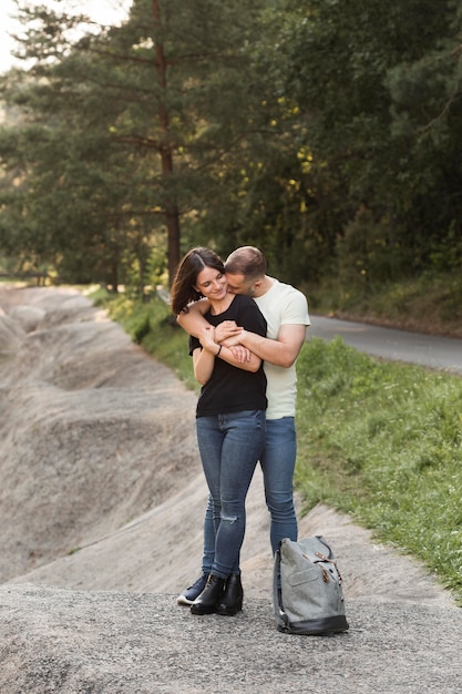 Full shot man hugging woman