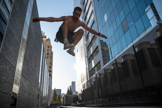 Full shot man jumping outdoors