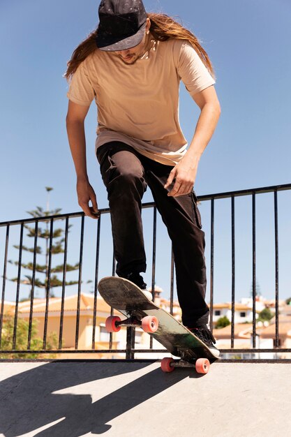 Full shot man jumping with skateboard