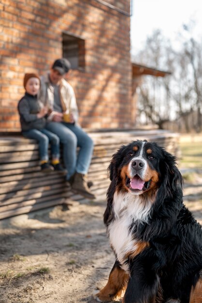 Full shot man, kid and dog outside