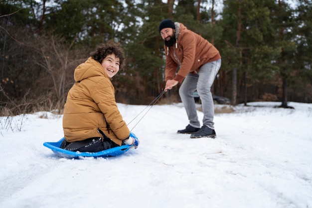 Full shot man and kid winter time