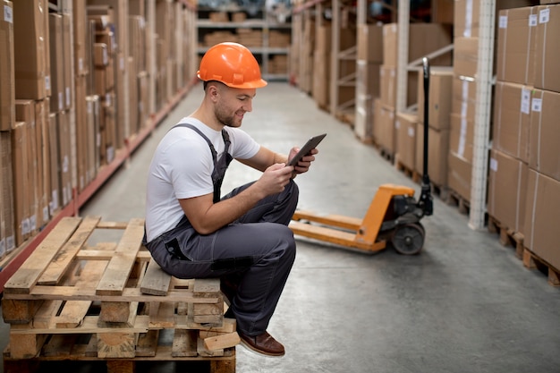 Full shot man in logistic warehouses