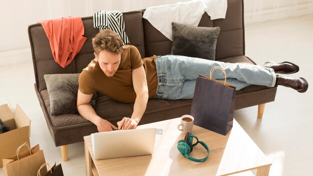 Full shot man looking at laptop