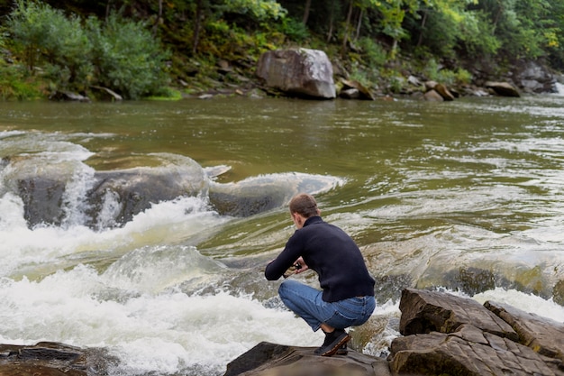 Free photo full shot man looking at river