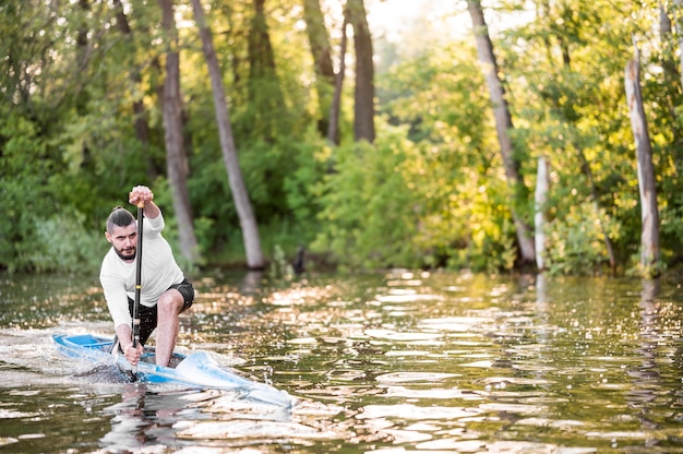 Full shot man paddling