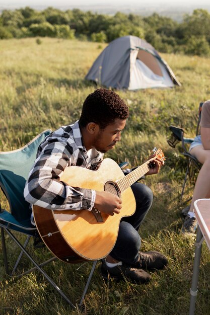 Full shot man playing the guitar