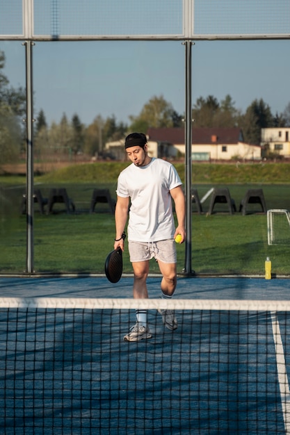Бесплатное фото Полный выстрел мужчина играет в паддл-теннис