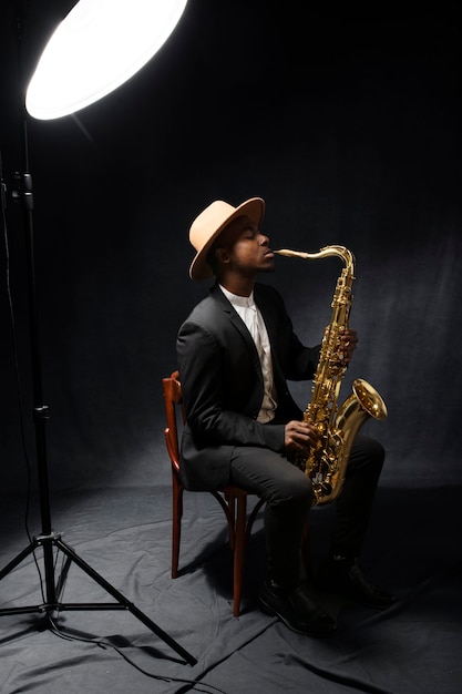 Full shot man playing saxophone