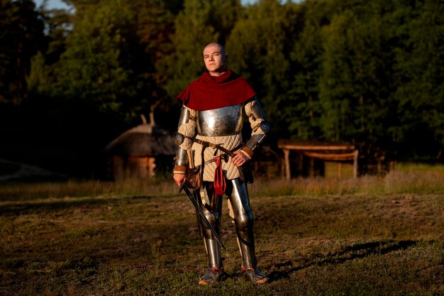 Full shot man posing as a medieval soldier