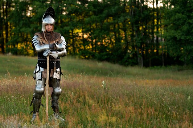 Full shot man posing as a medieval soldier