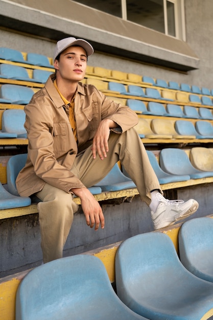 Free photo full shot man posing in grandstands