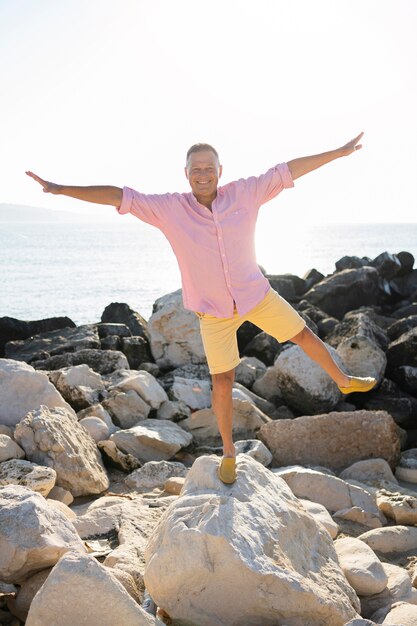 Full shot man posing on rocks