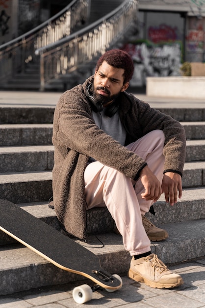 Full shot man posing on stairs