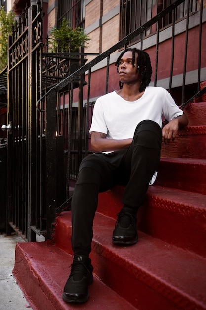 Full shot man posing on stairs