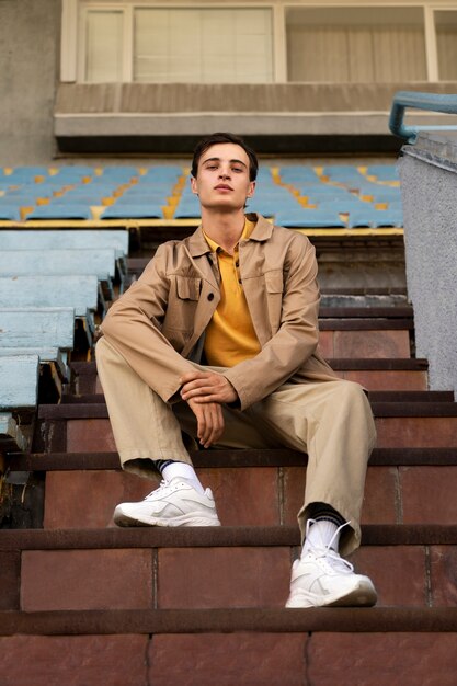 Full shot man posing on stairs