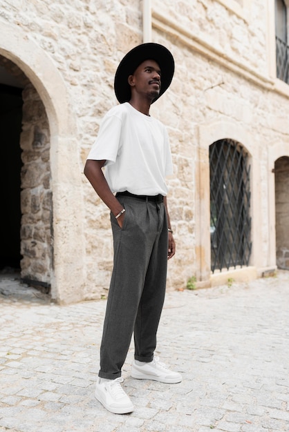 Full shot man posing with hat