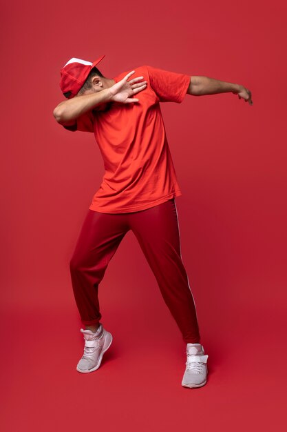 Full shot man posing with red background