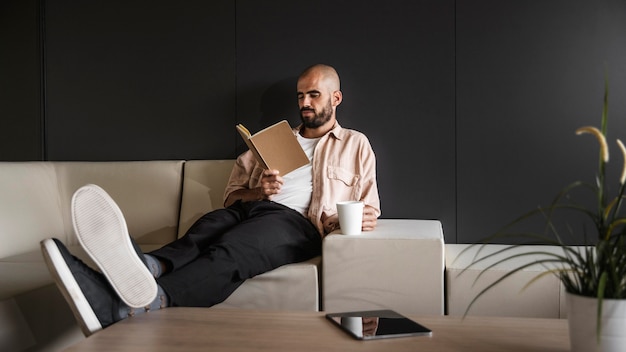 Full shot man reading book